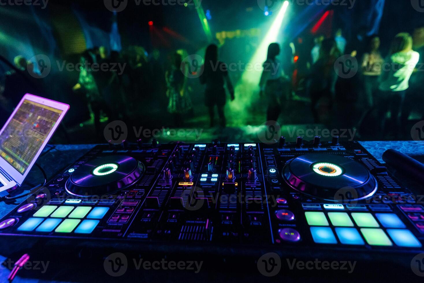 professional DJ mixer controller for mixing music in a nightclub photo