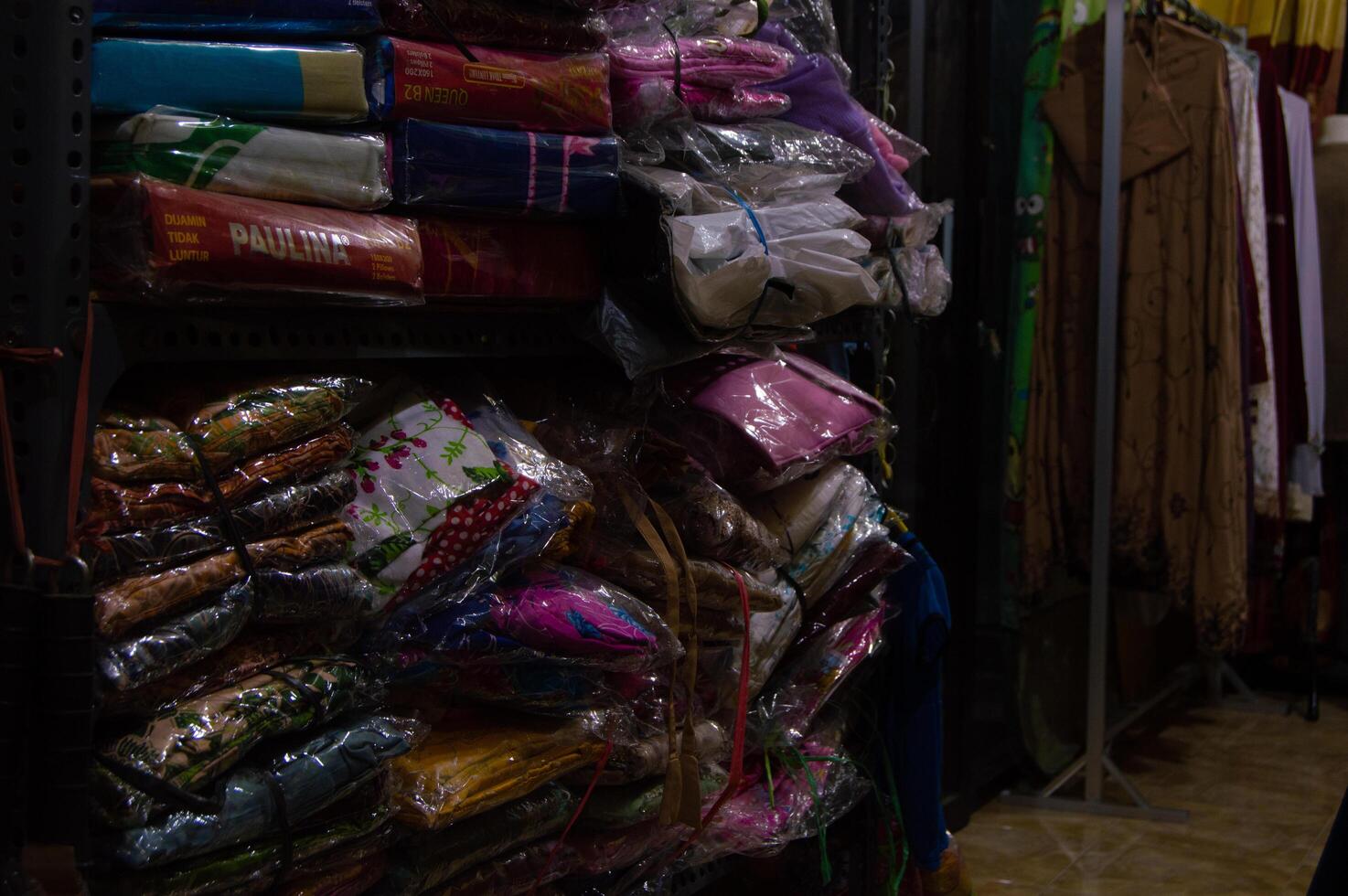 Gresik, Indonesia, 20 March 2023 - piles of clothes on a shop shelf photo