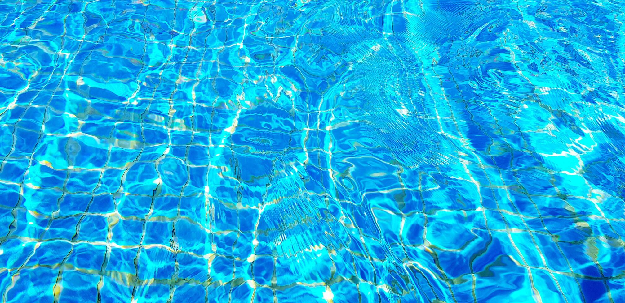 Wave or ripple water in swimming pool with sunlight reflection for background. Art or Abstract and Wallpaper concept. photo