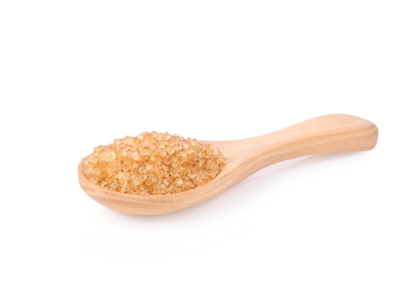 Brown cane sugar in wooden spoon on white background photo
