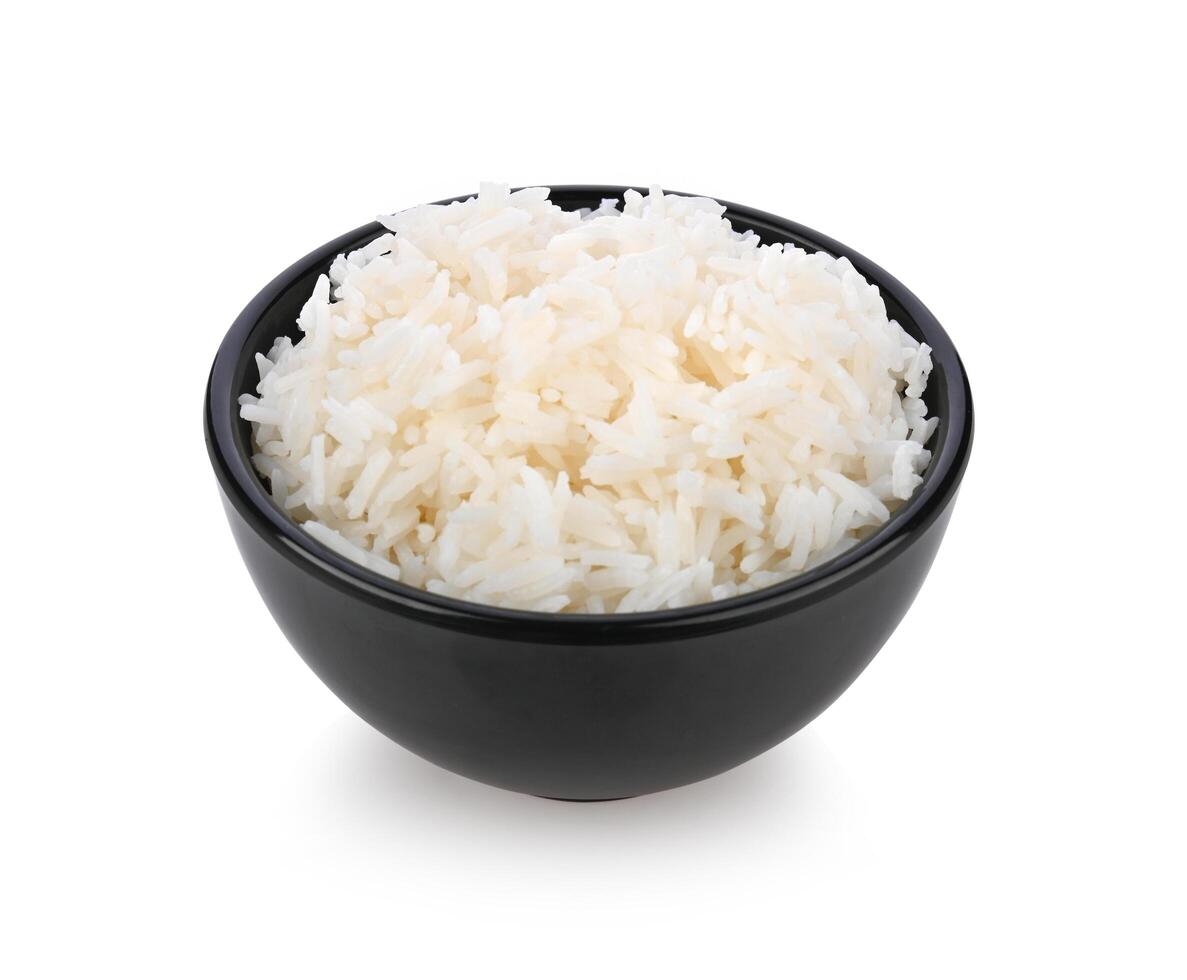 Rice in black bowl on white background photo