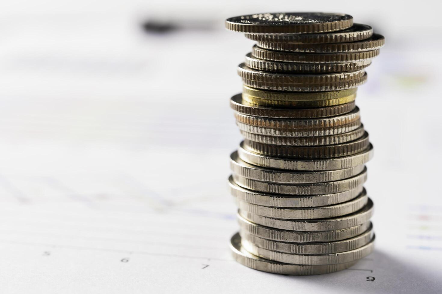 Coins are placed on business reports, business concepts and finance. photo