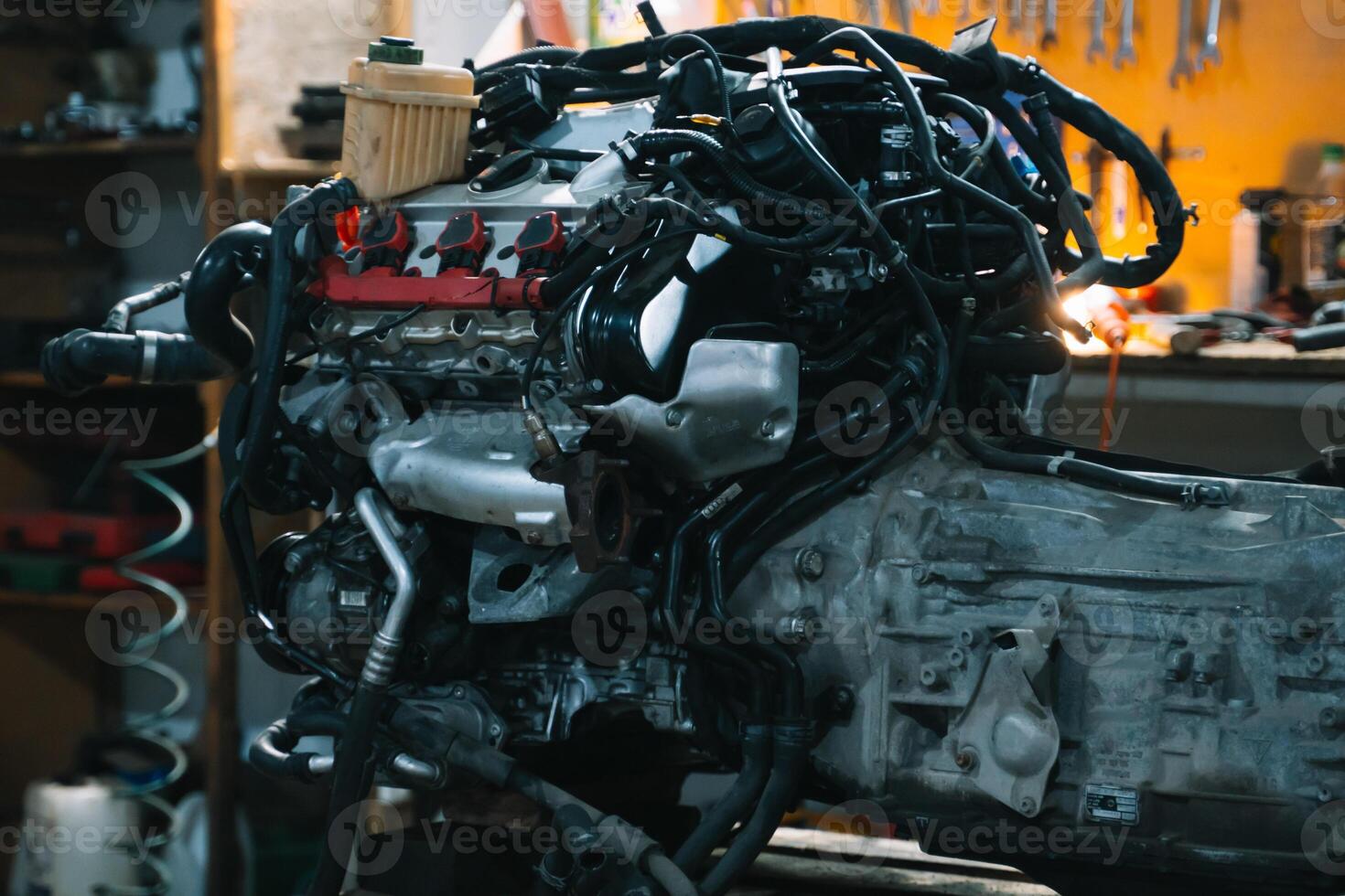 Broken car engine at car service station. Rise car engine unit photo