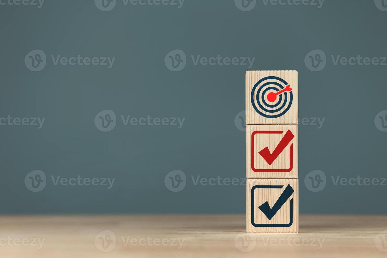 Target icon and checkmark on a wooden block. Concept of planning for goals of success, plan review, and project list. photo