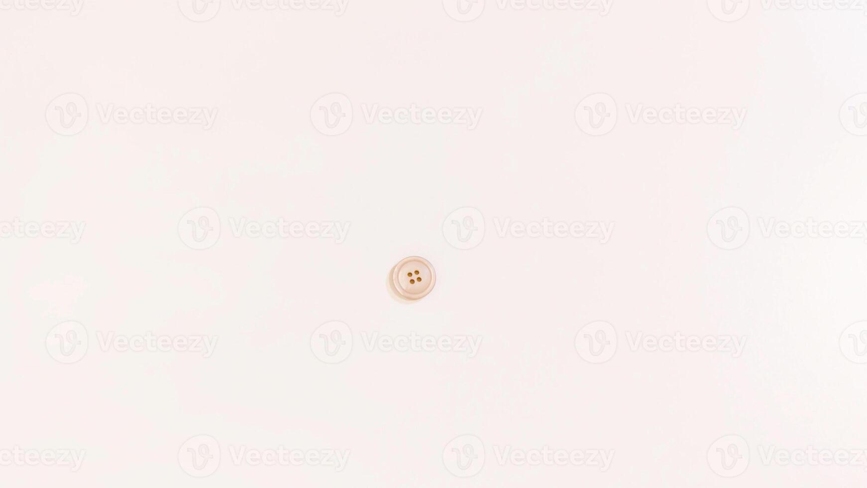 Buttons of various colors and shapes scattered on a white background. photo