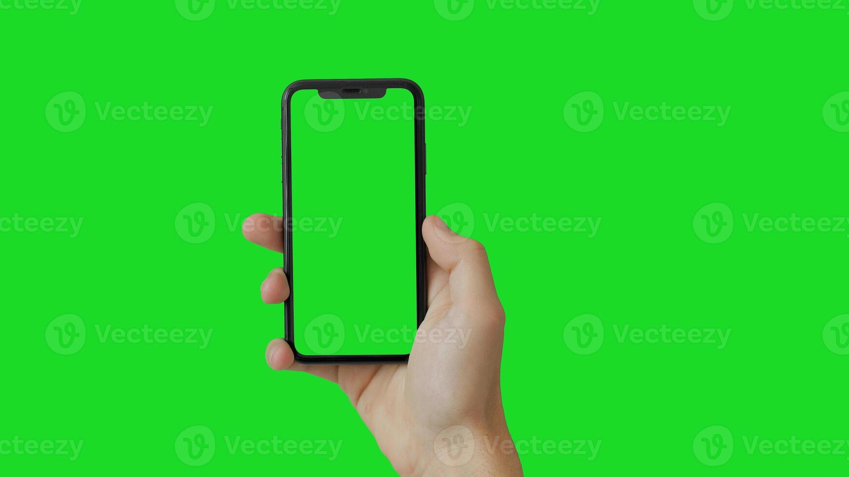 Modern smart phone in hand close-up. Isolated screen and background in green. photo