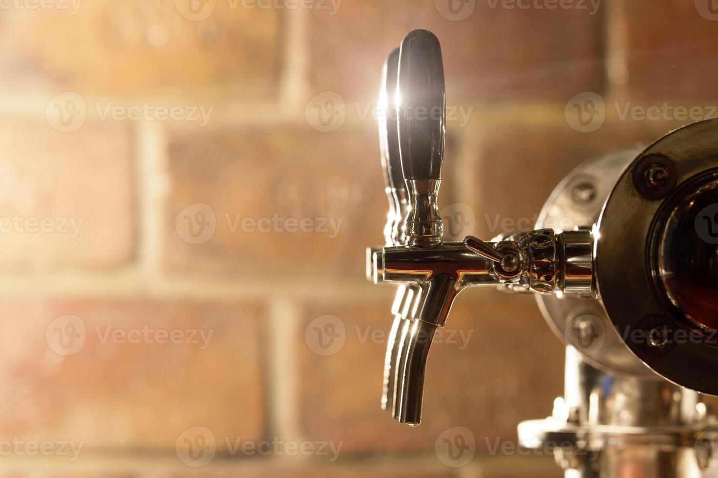 man bartender hand at beer tap pouring beer in glass in bar or pub photo