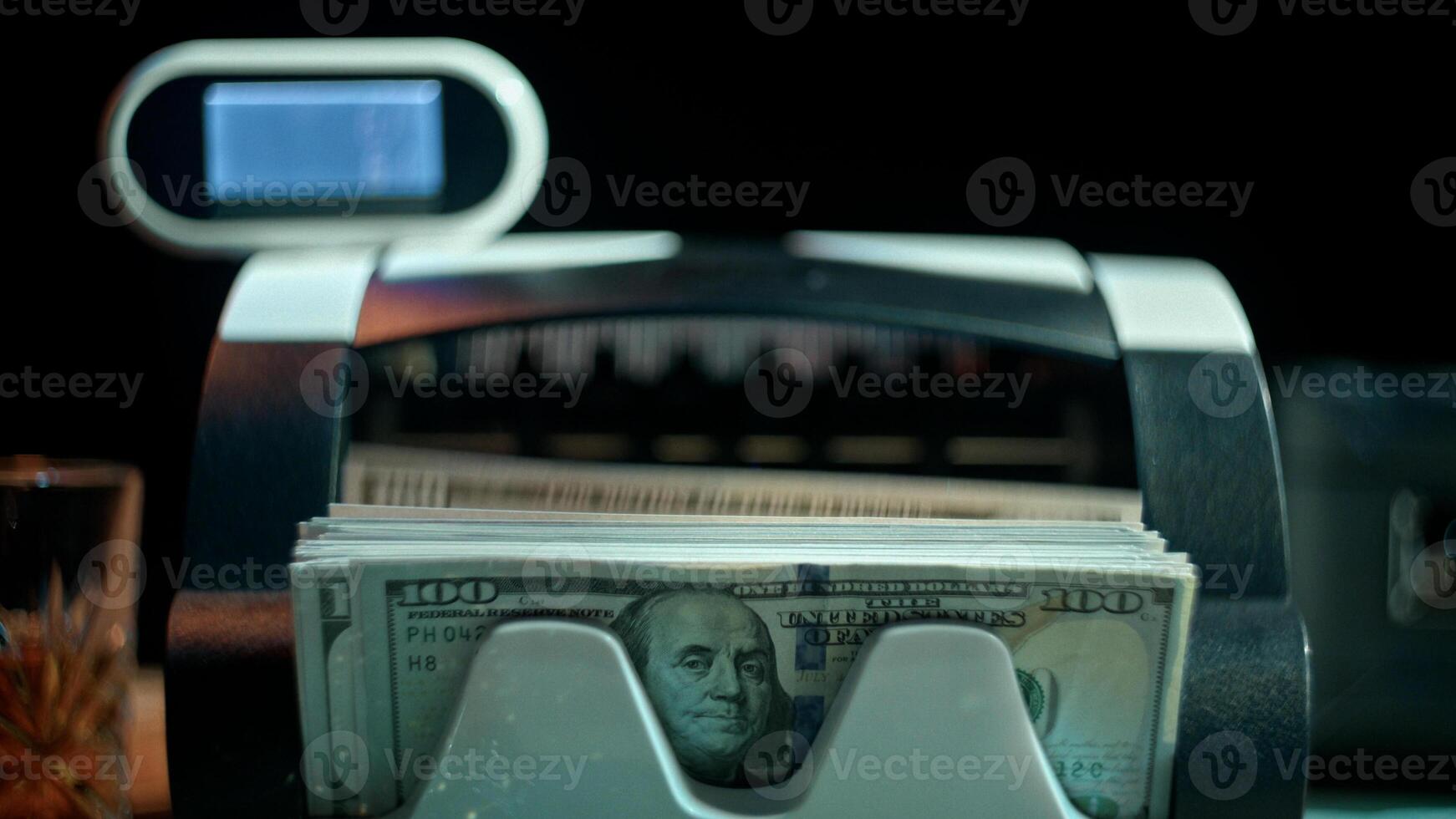 Money counter is counting paper money one hundred American dollar photo