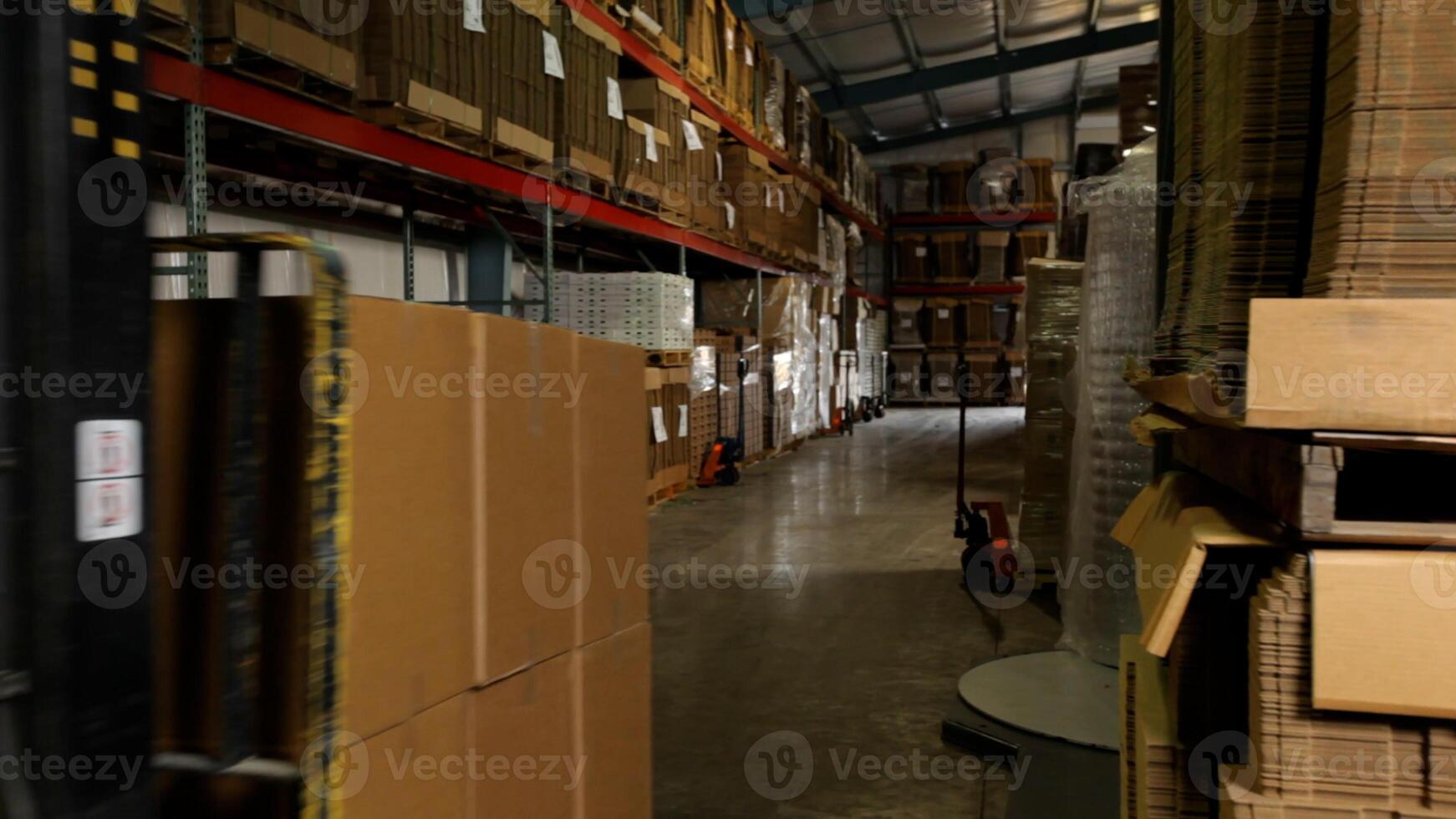 Electric forklift in warehouse loading cardboard boxes photo