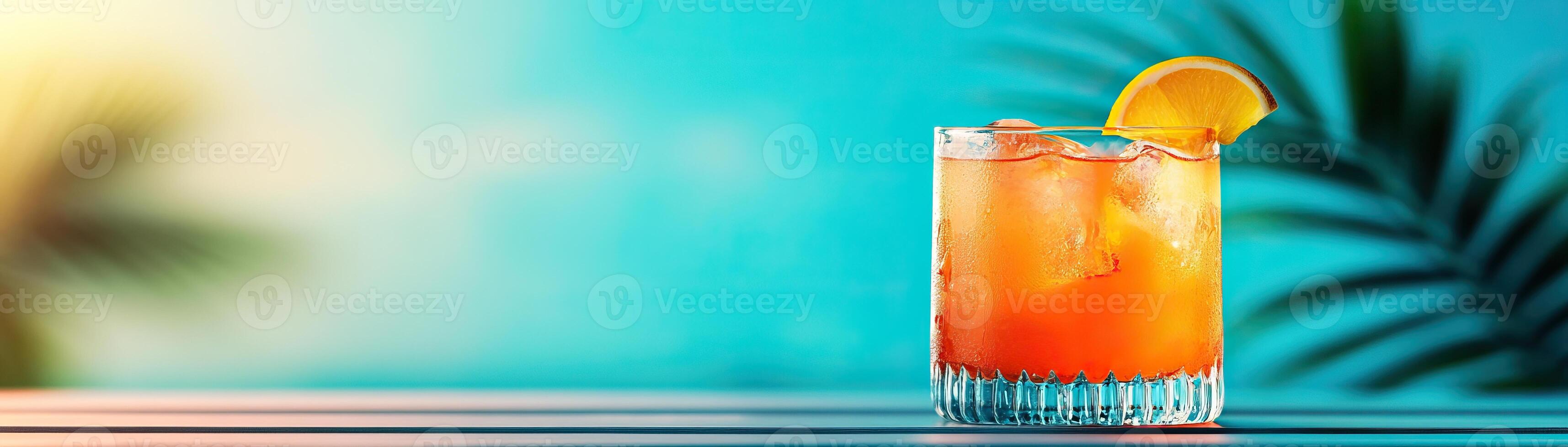 A refreshing cocktail with ice and orange slice, perfect for summer vibes and beach settings under a vibrant blue sky. photo