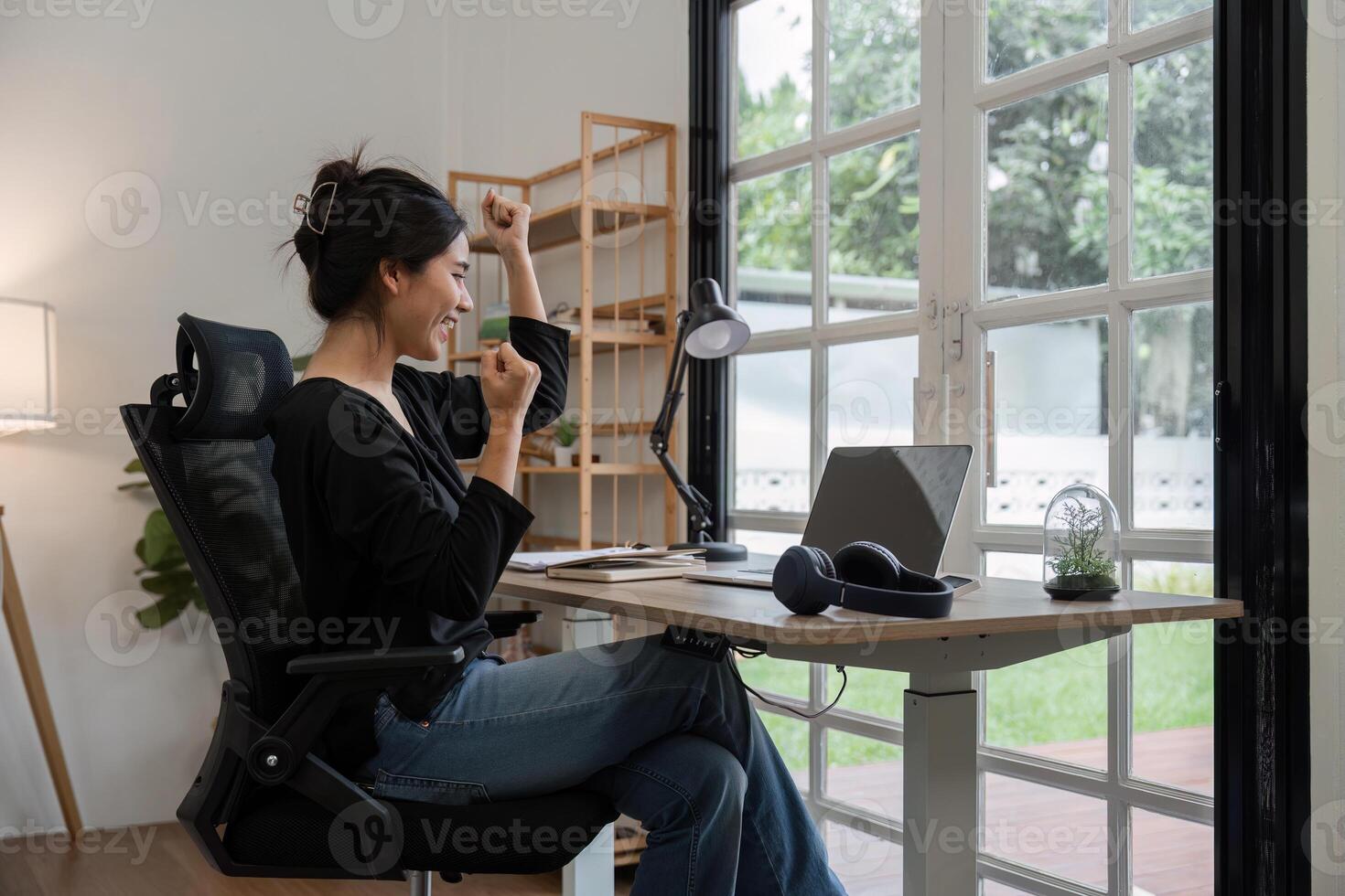 Young Accountant Working on Financial Documents in a Modern Home Office with Natural Light and Greenery Outside photo