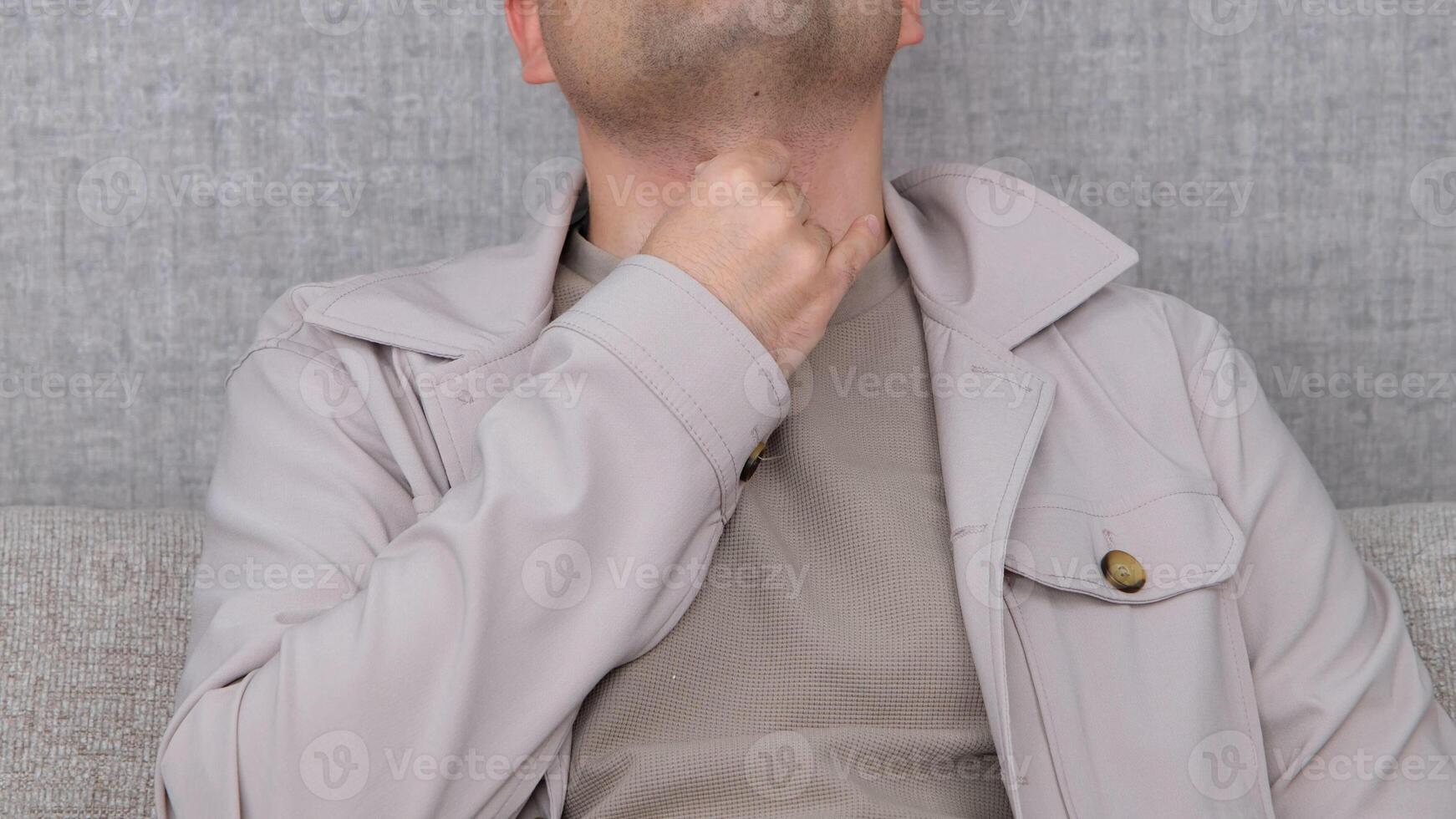 man thyroid gland control man with throat pain Mature male touches his neck at home Disorder of the endocrine system Hashimotos Thyroiditis, Lymphocytic Thyroiditis. photo