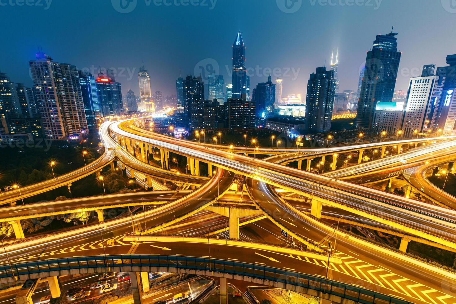 View over the famous highway intersection in Shanghai, China, with illuminated highways and modern architecture. Shanghai skyline by night. photo