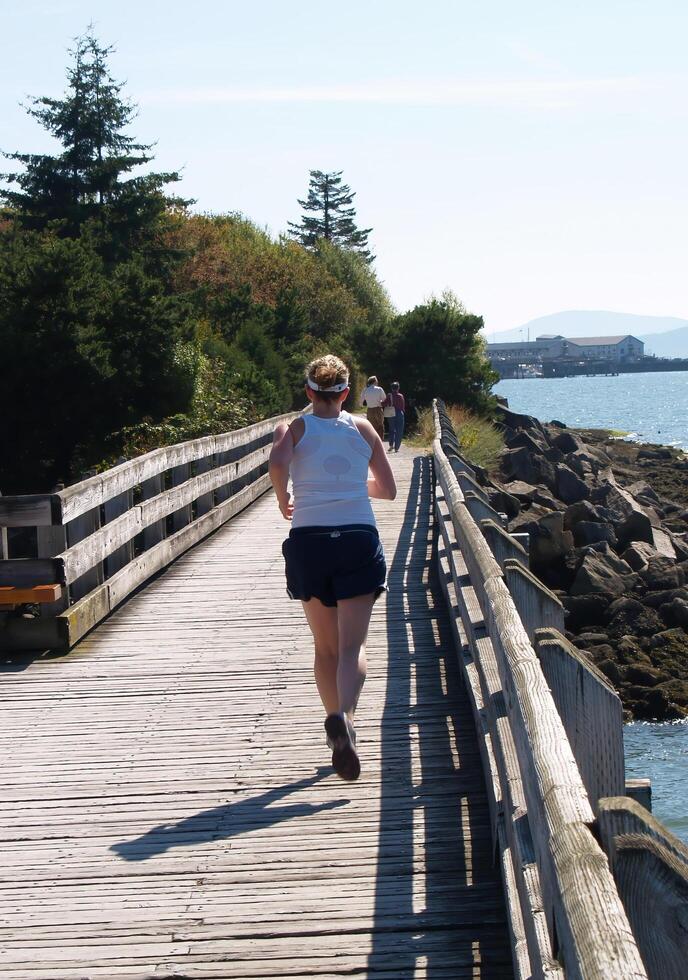 Birch Bay, WA, 2006 - Wooden Boardwalk Next To Bay With Jogger And Couple Walking photo