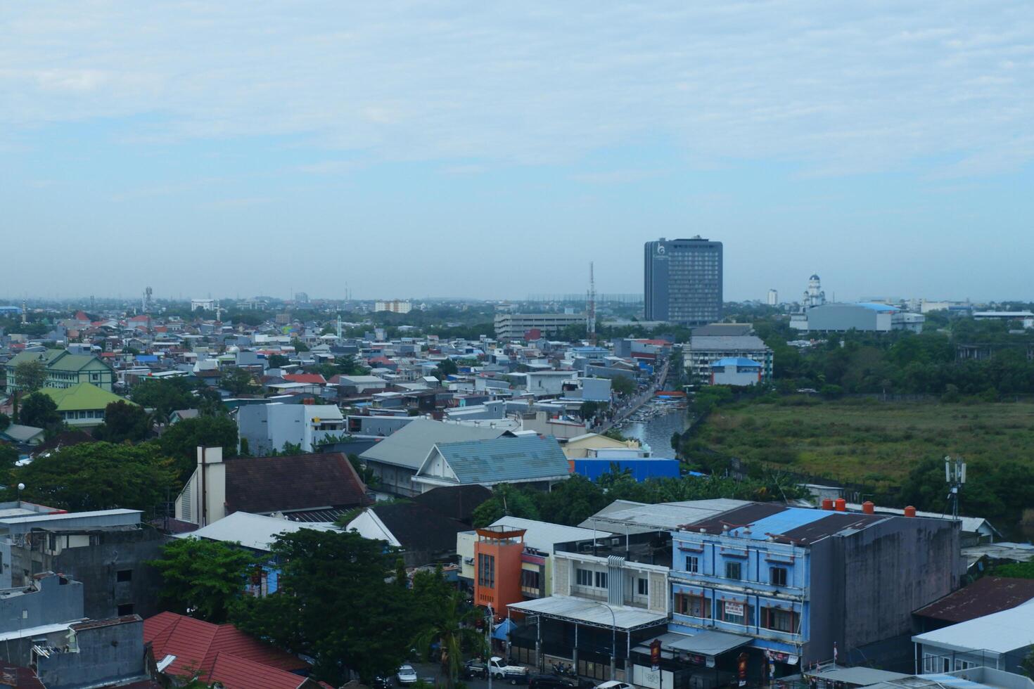 buildings with a bright blue sky background in the city of Makassar, Indonesia photo