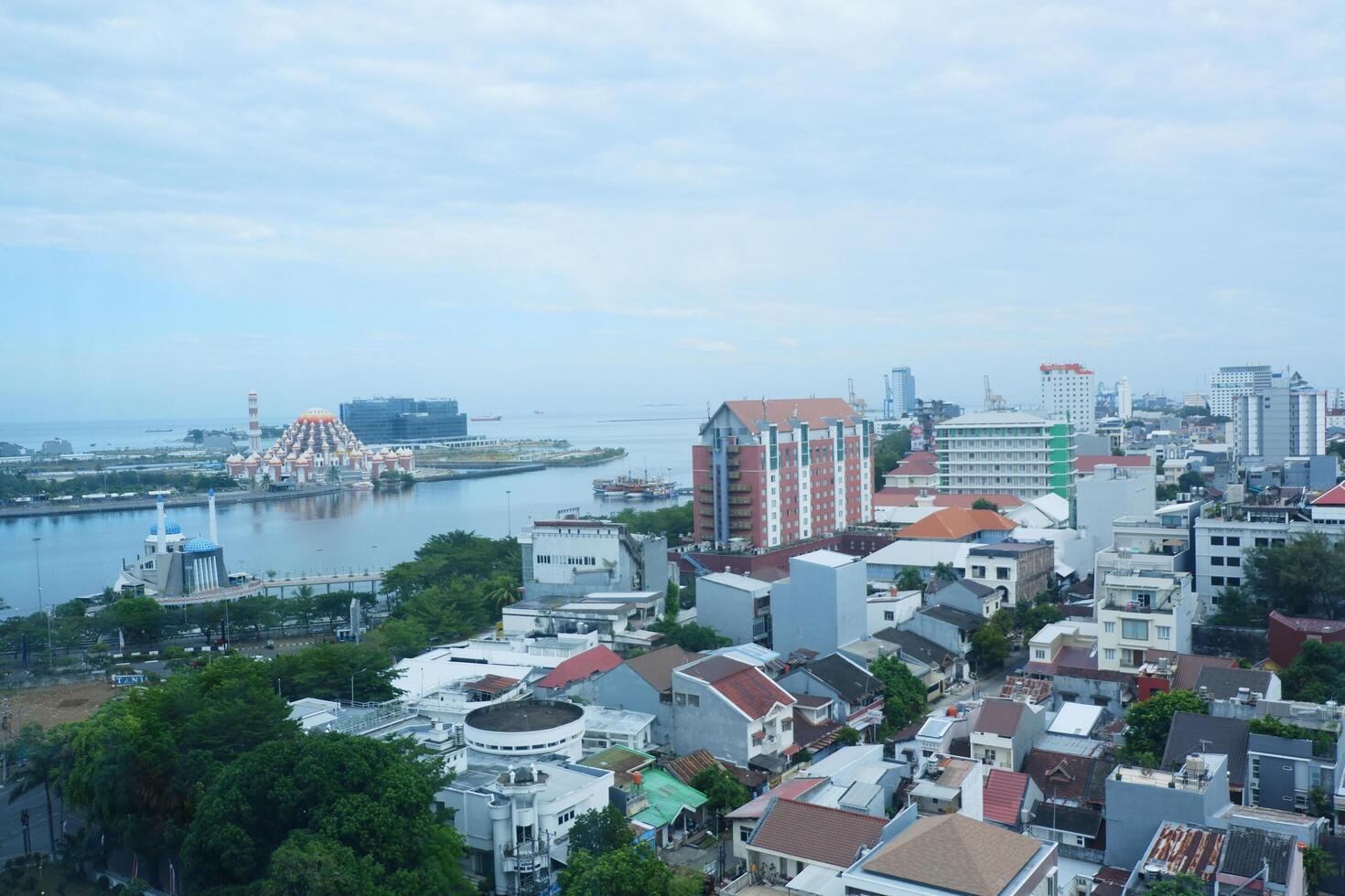 buildings with a bright blue sky background in the city of Makassar, Indonesia photo
