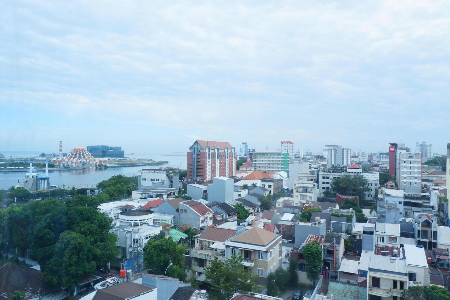 buildings with a bright blue sky background in the city of Makassar, Indonesia photo