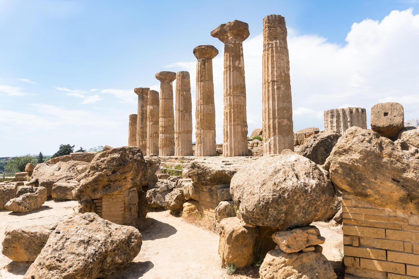 Agrigento, Italy-May 10, 2022-view of the columns oh the Temple of Hercules inside the valley of the temples, an archaeological park near Agrigento during a sunny day photo