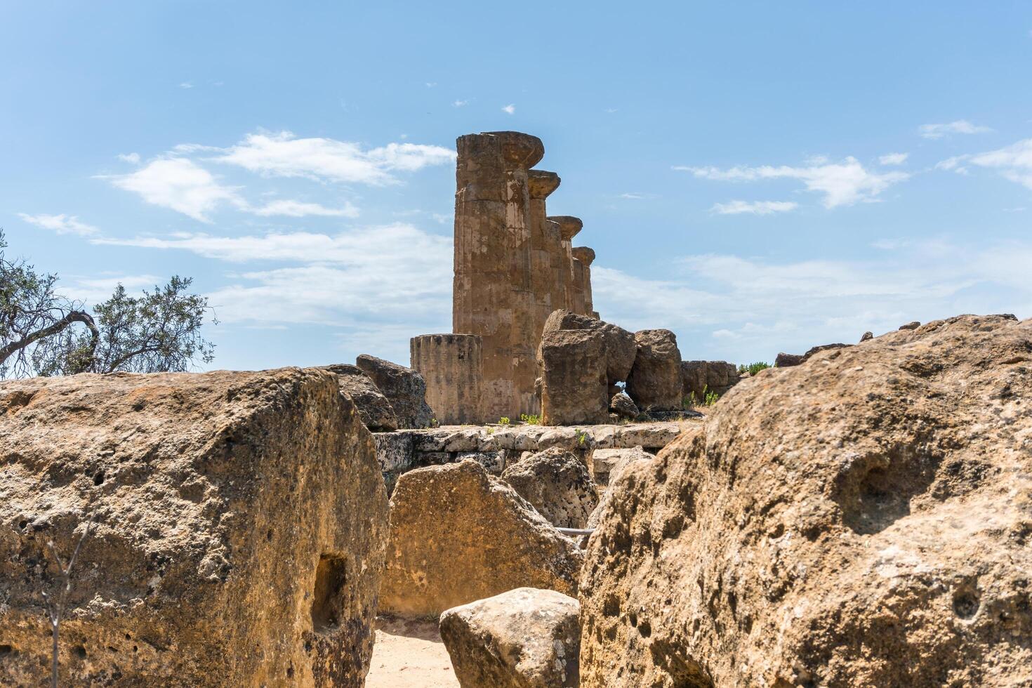 Agrigento, Italy-May 10, 2022-view of the columns oh the Temple of Hercules inside the valley of the temples, an archaeological park near Agrigento during a sunny day photo