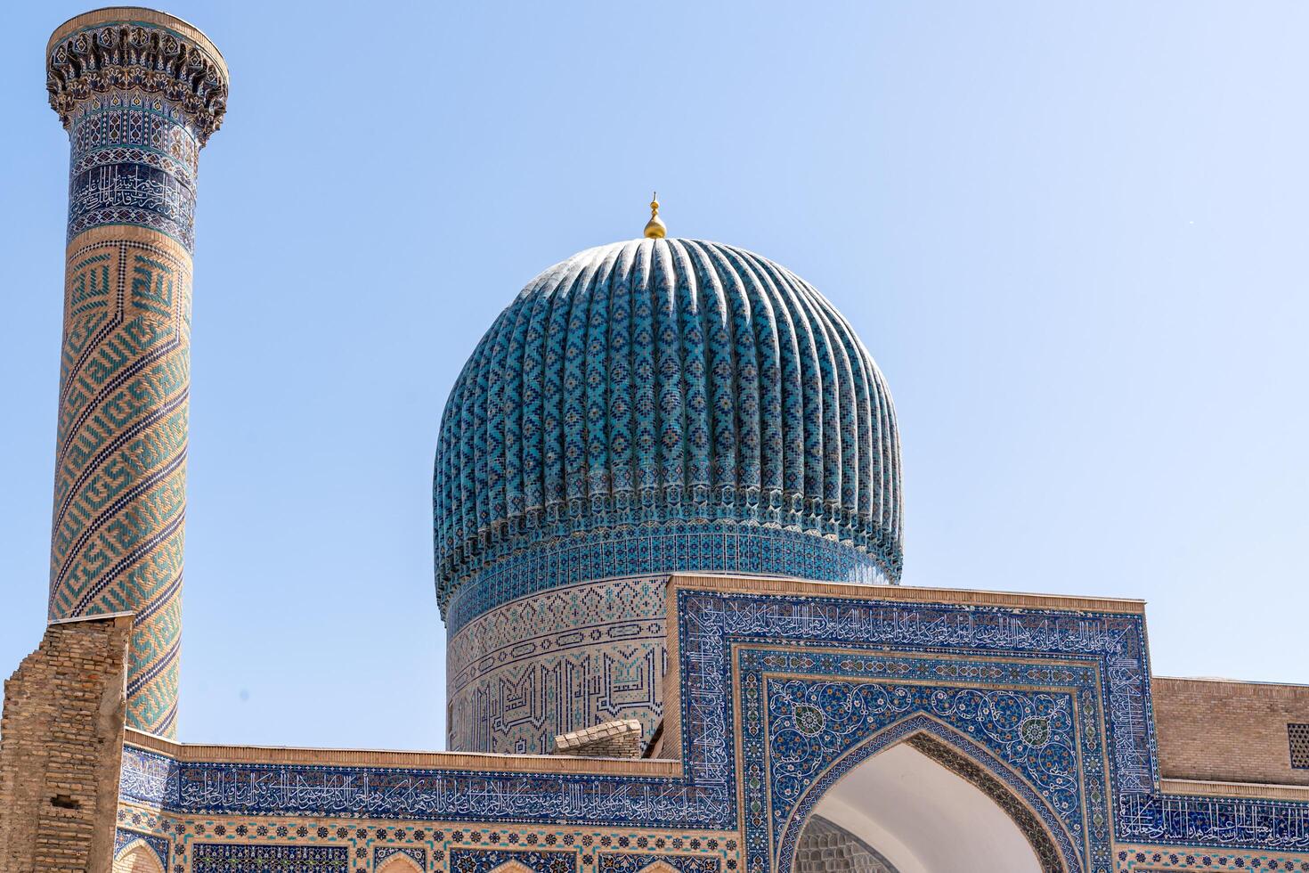 Tashkent, Uzbekistan-august 12, 2023-particular of the entrance of the Tamerlane Mausoleum with decorated tombs, mosaics and carvings during a sunny day photo