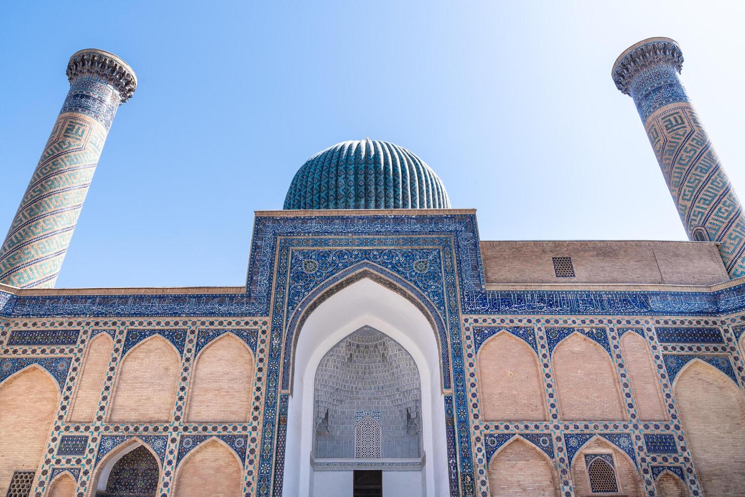 Tashkent, Uzbekistan-august 12, 2023-particular of the entrance of the Tamerlane Mausoleum with decorated tombs, mosaics and carvings during a sunny day photo