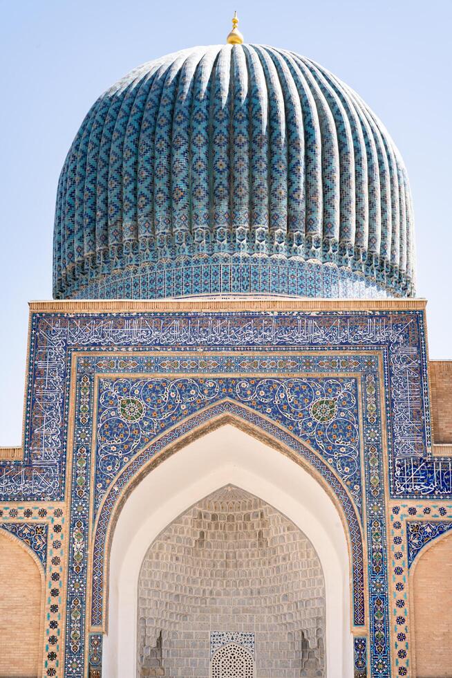 Tashkent, Uzbekistan-august 12, 2023-particular of the entrance of the Tamerlane Mausoleum with decorated tombs, mosaics and carvings during a sunny day photo