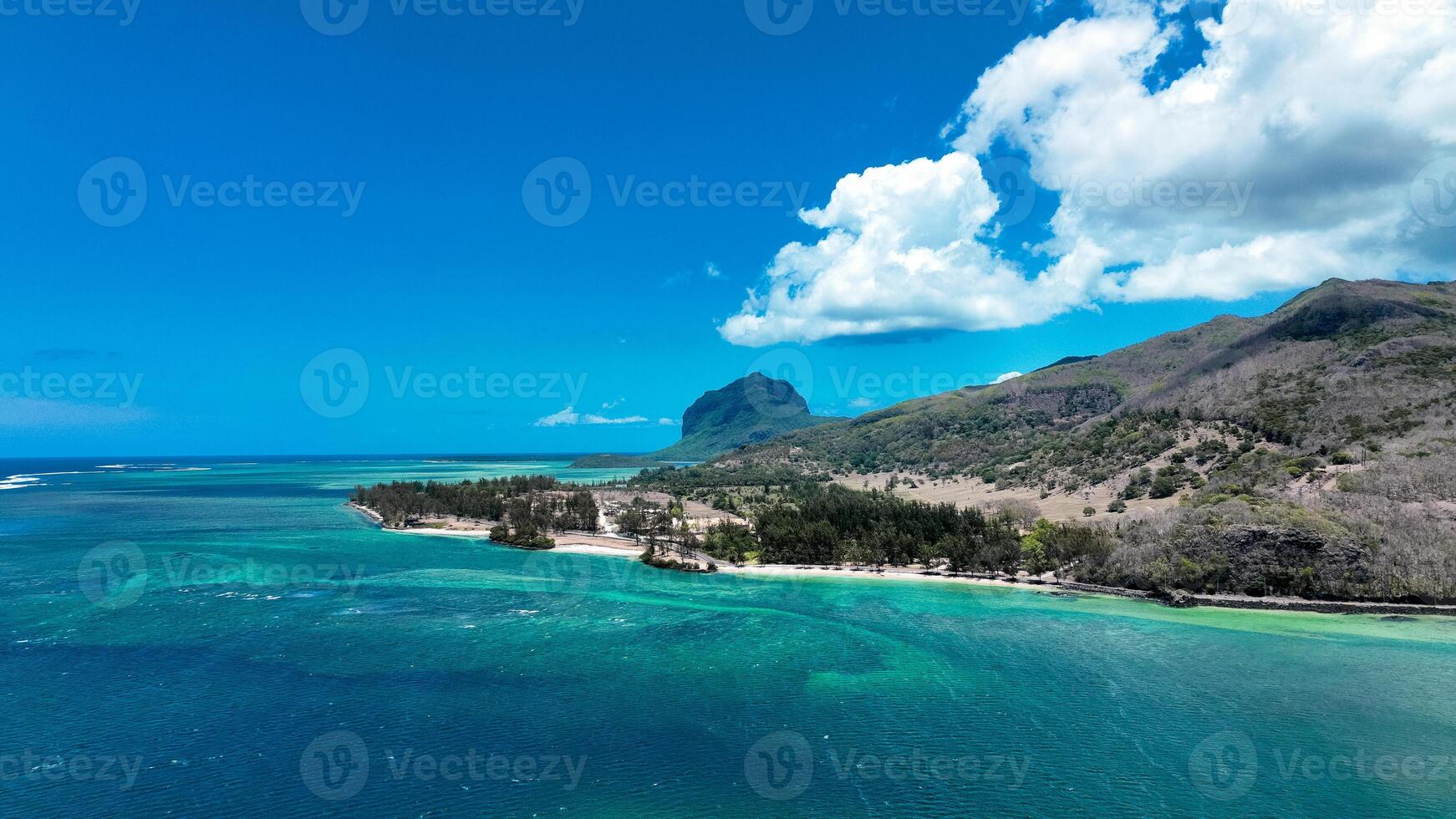 An aerial view showcasing the beautiful rural landscape of Mauritius with majestic mountains in the background. photo