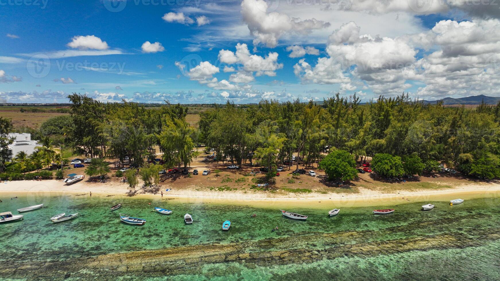 An aerial view showcasing the beautiful rural landscape of Mauritius with majestic mountains in the background. photo