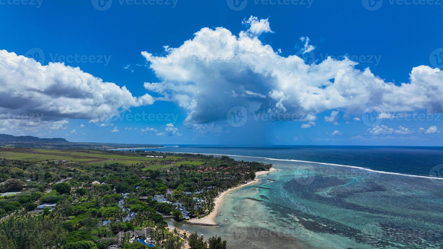 An aerial view showcasing the beautiful rural landscape of Mauritius with majestic mountains in the background. photo