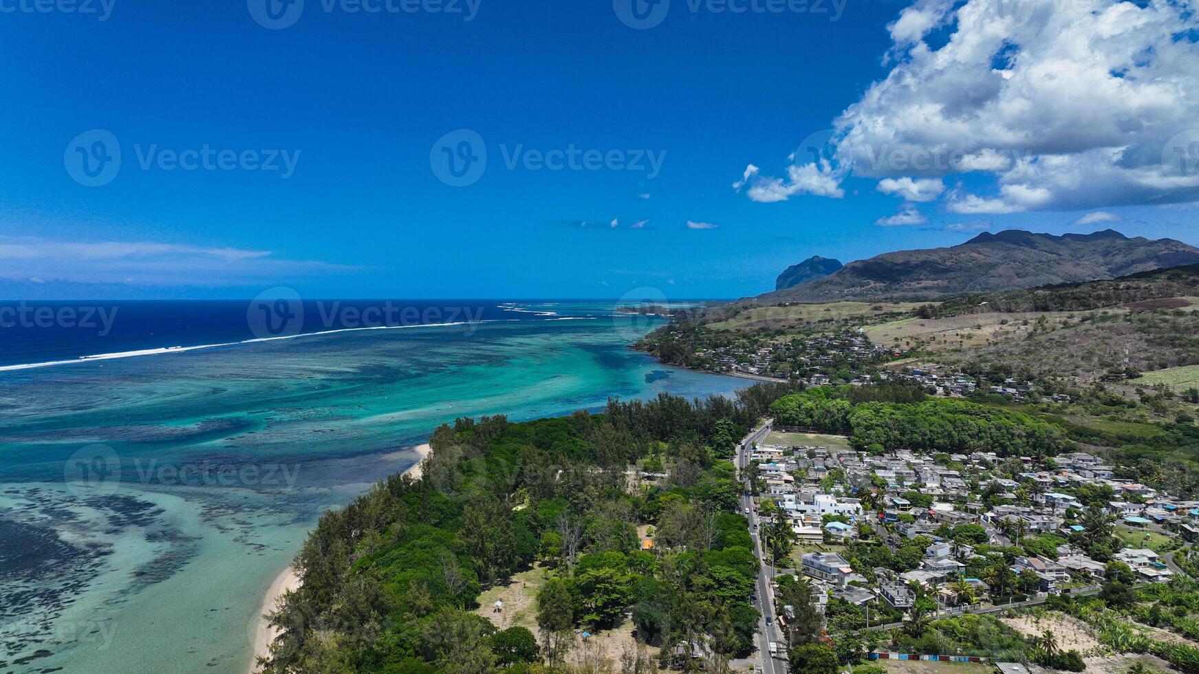 An aerial view showcasing the beautiful rural landscape of Mauritius with majestic mountains in the background. photo