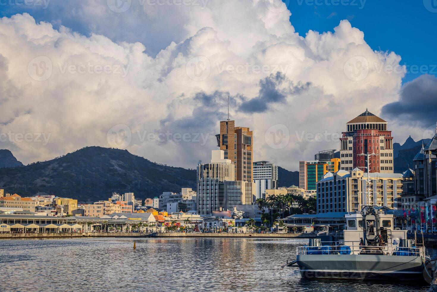 A photograph capturing the view of Port Louis City in Mauritius, showcasing its remarkable skyline filled with numerous towering buildings. photo