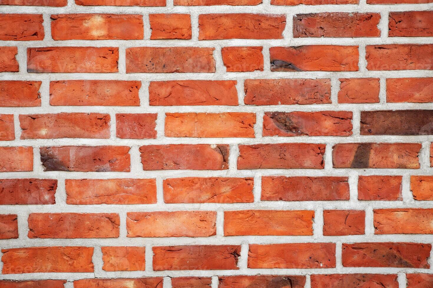 Red brick wall texture background with weathered bricks, cement joints, and an aged, grungy appearance photo