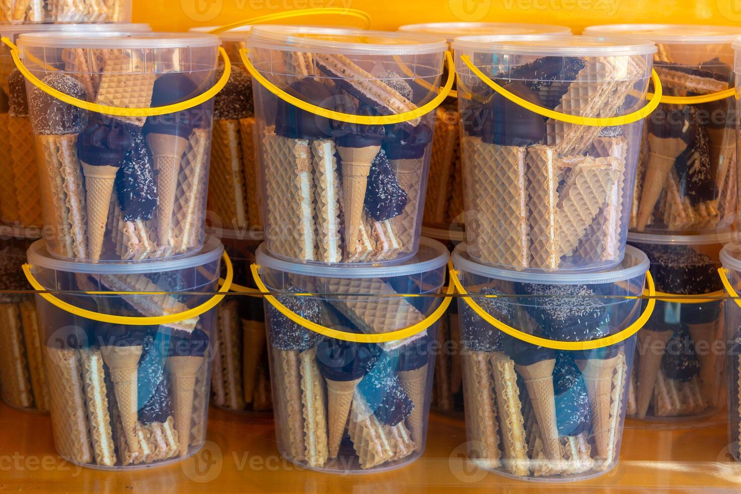 stack of containers with waffle cones and chocolate sauce photo
