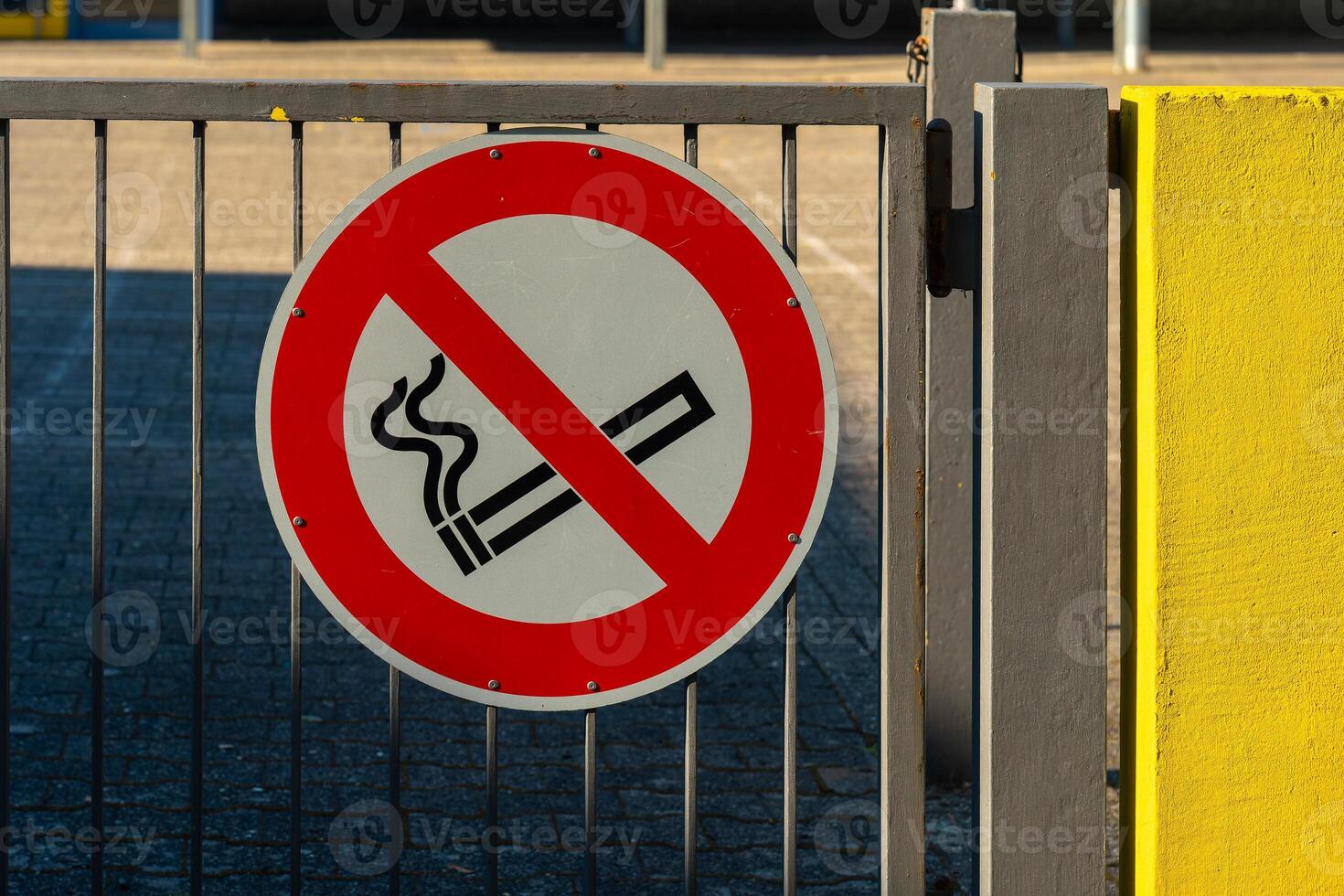 red and white sign with a no smoking symbol on it photo