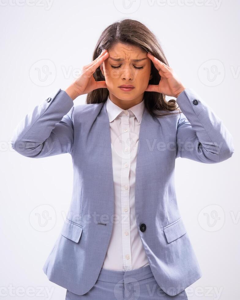 Portrait of pensive and exhausted businesswoman who is having headache. photo