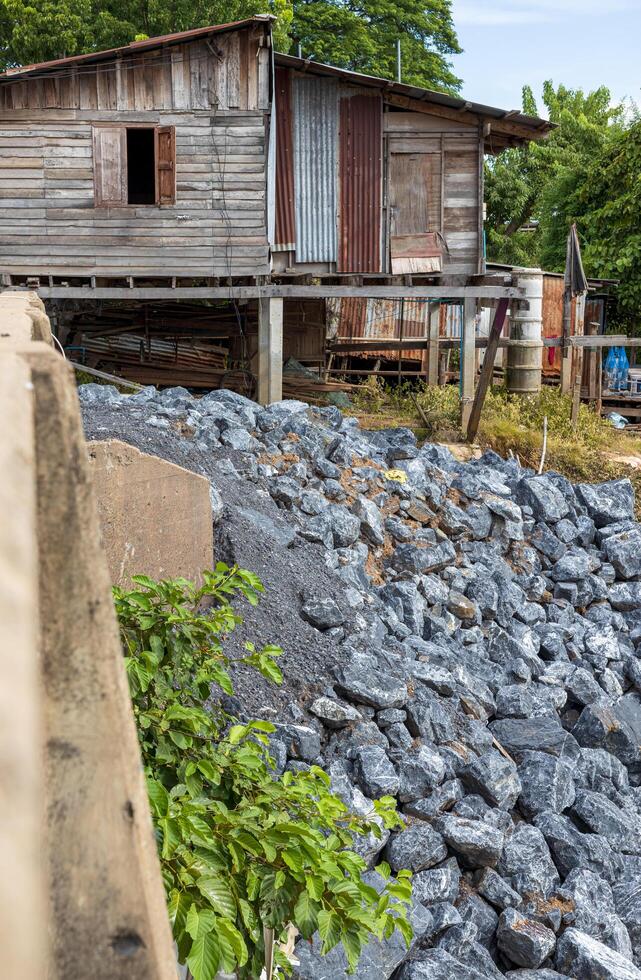 Side view of large granite boulders piled up on a riverbank mound. photo
