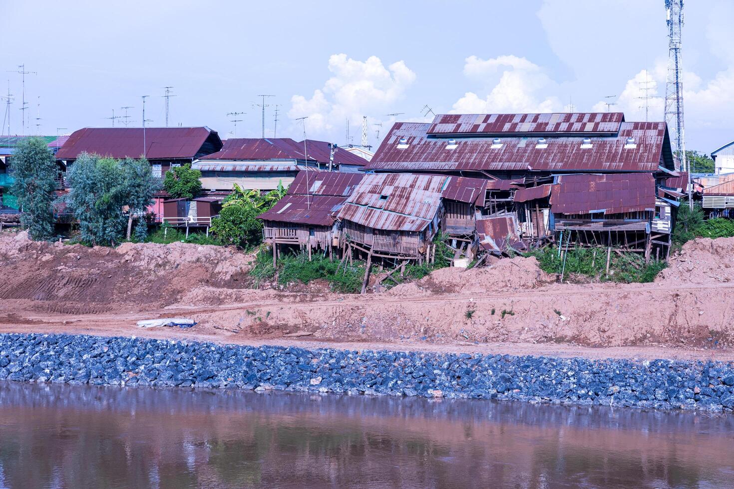 A view of old tin-roofed wooden houses near collapse. photo