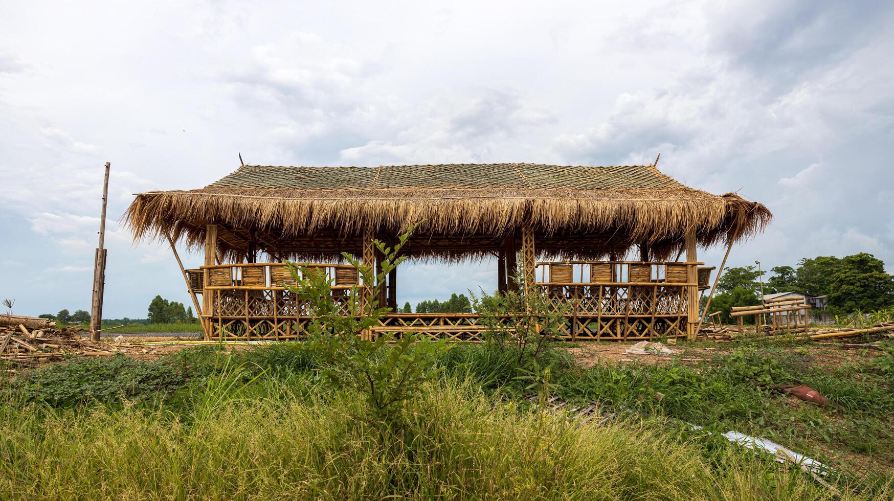 Low angle view of a bamboo frame shelter hut with a vetiver grass roof. photo