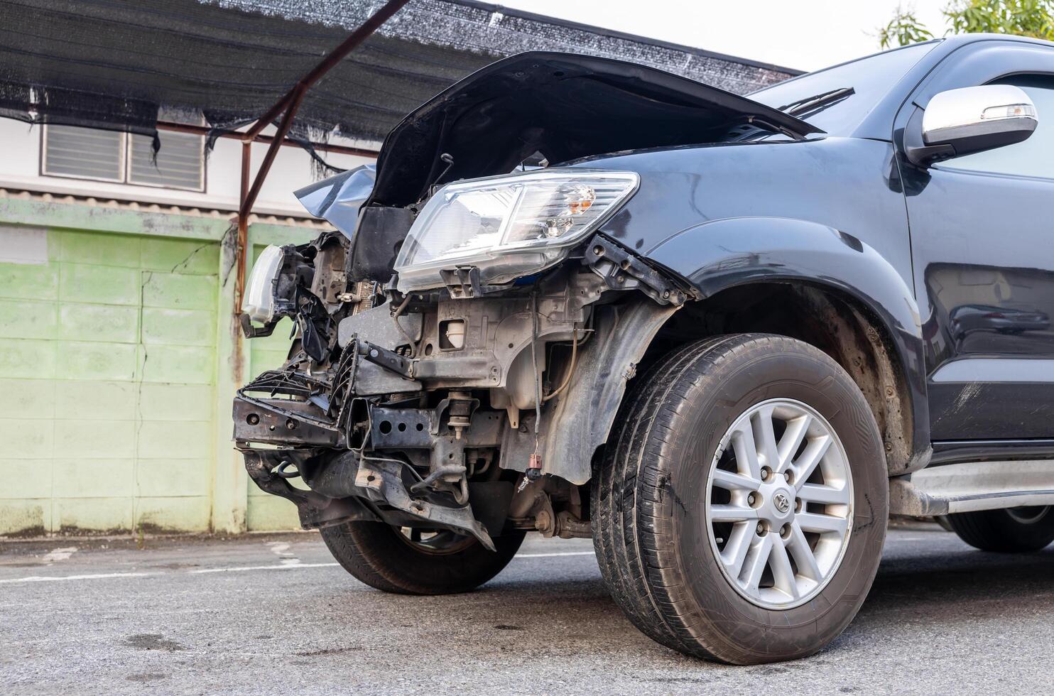 Front of a black car which was destroyed. photo