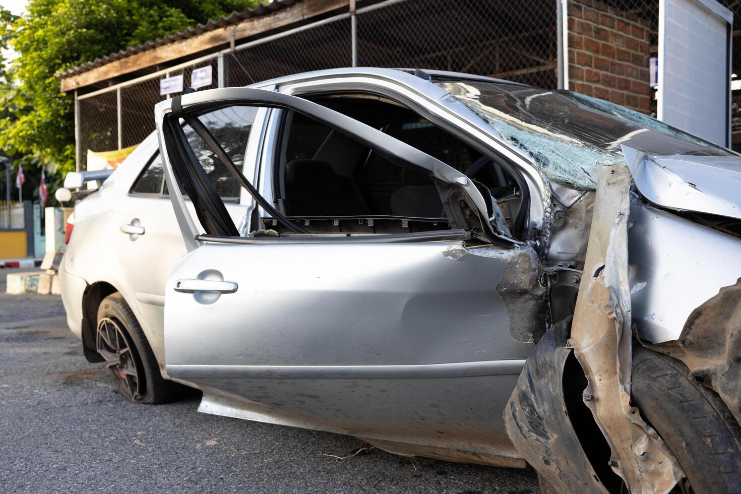 A close-up view of the condition of a silver-colored sedan destroyed in an accident. photo