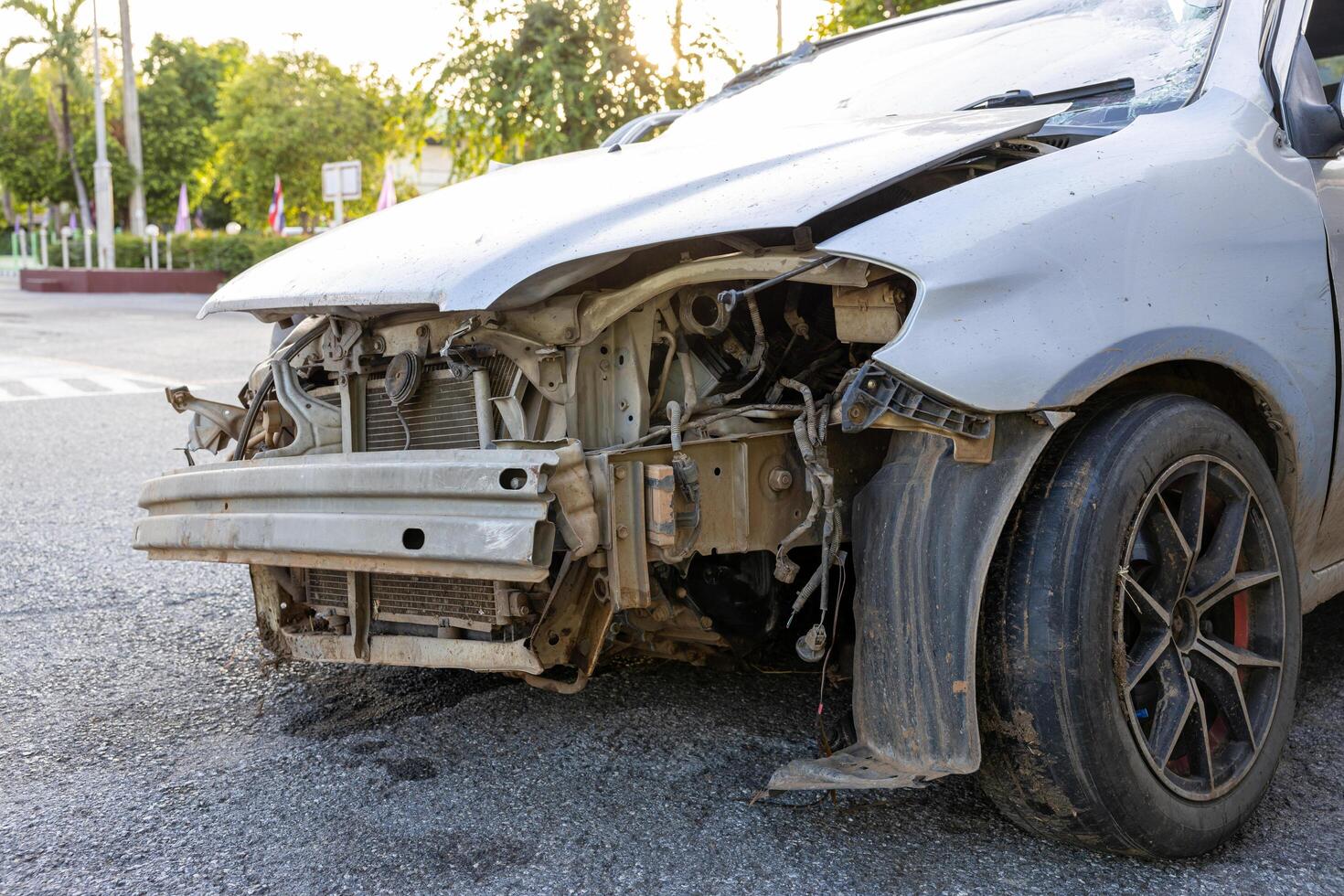 A close-up view of the condition of a silver-colored sedan destroyed in an accident. photo