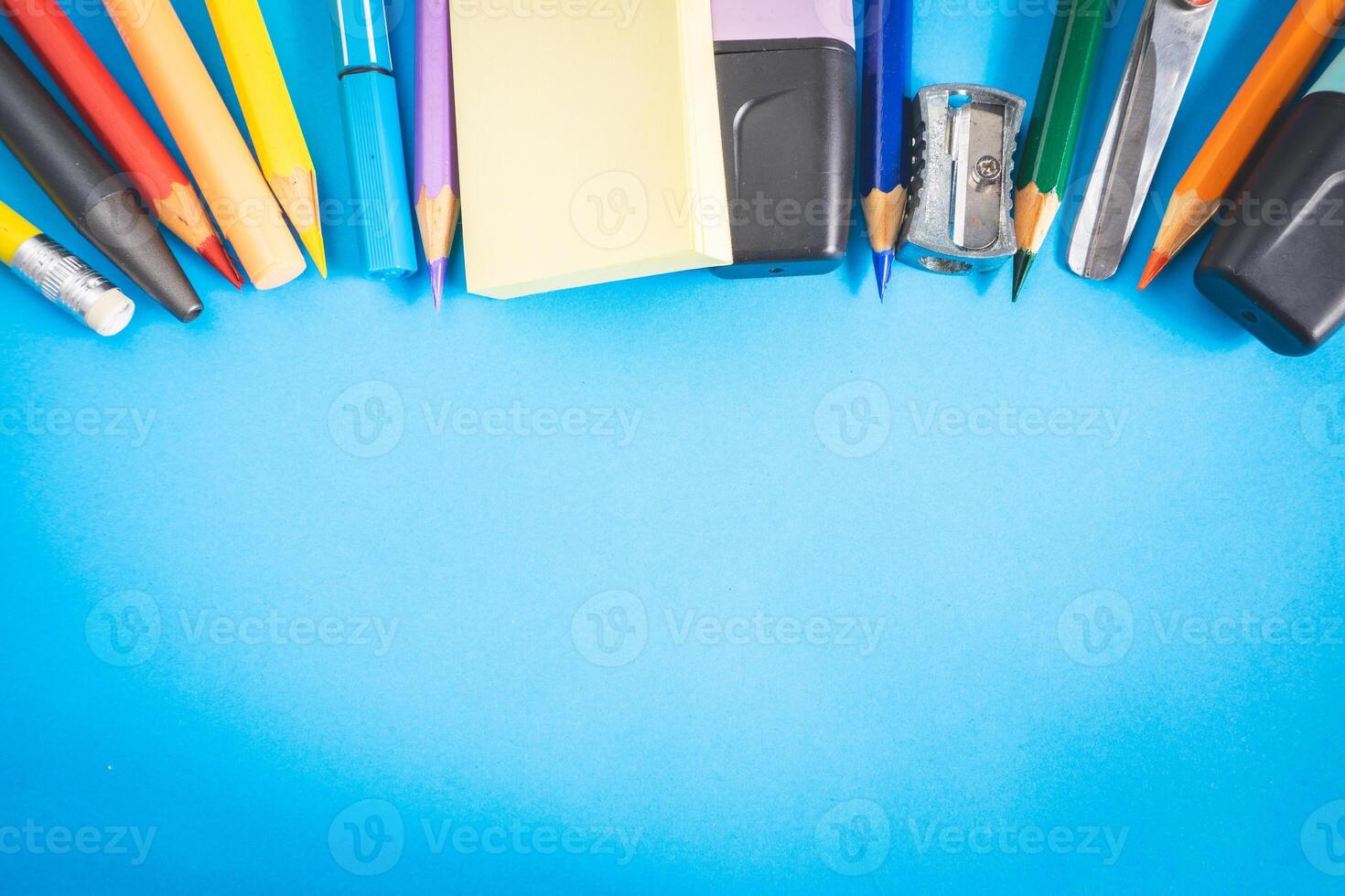 Different kind of school, office supplies for studying, on a blue background. Back to school. photo
