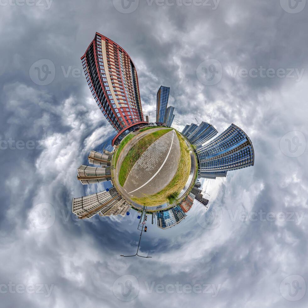 abstract swirling tiny planet spherical panorama of multi-storey buildings of skyscrapers of a residential complex in the form of a butterfly, bugs, crabs in blue sky photo