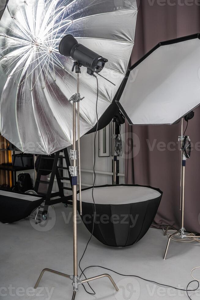interior of bright space of photo studio with lighting equipment