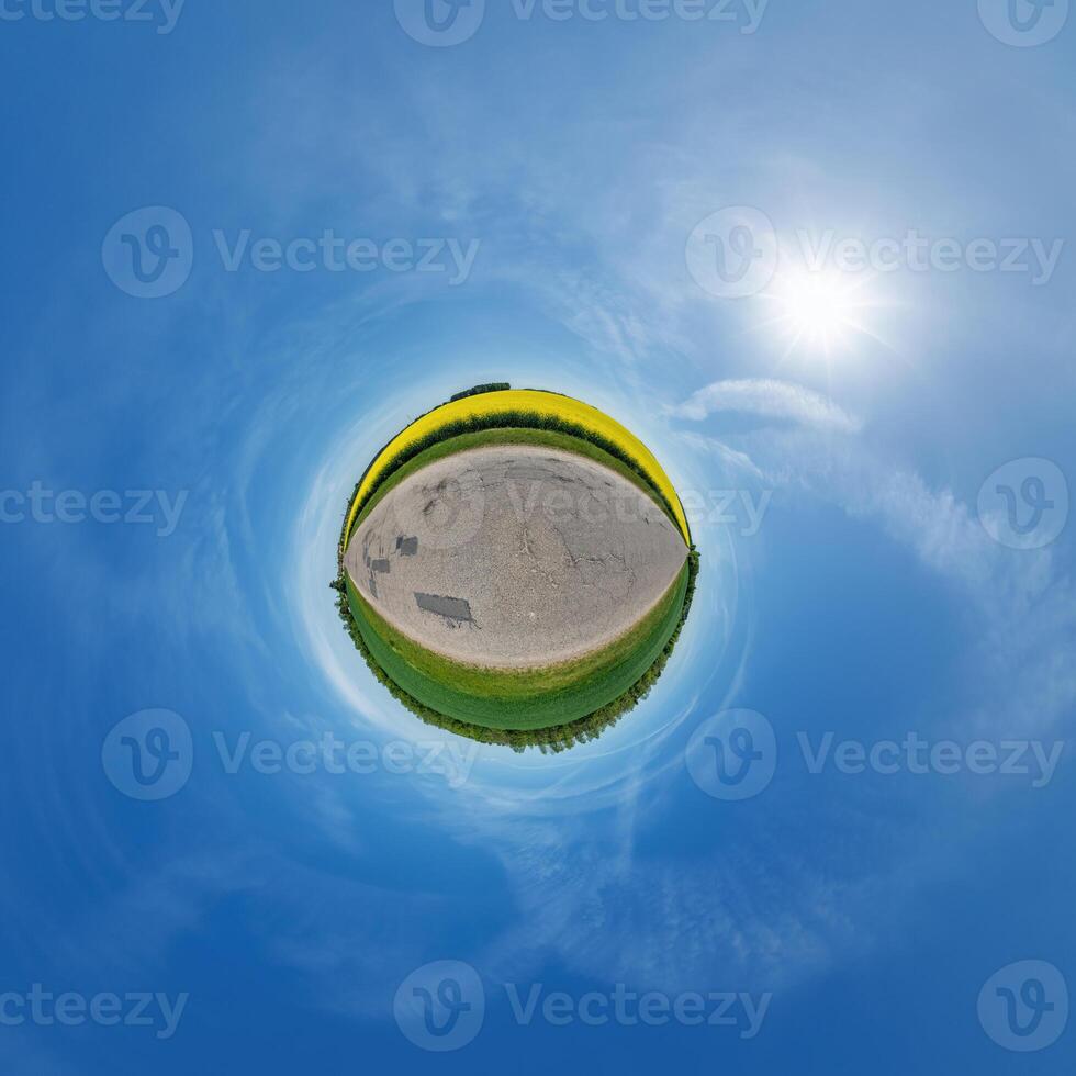 simple little tiny planet without buildings in blue sky with beautiful clouds. Transformation of spherical panorama 360 degrees. Spherical abstract aerial view. Curvature of space. photo