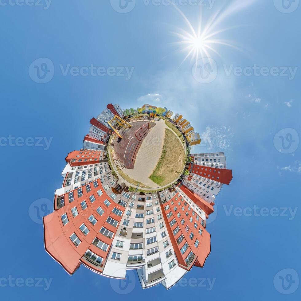 abstract swirling tiny planet spherical panorama of multi-storey buildings of skyscrapers of a residential complex in the form of a butterfly, bugs, crabs in blue sky photo