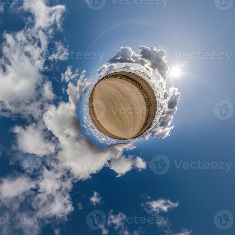 simple little tiny planet without buildings in blue sky with beautiful clouds. Transformation of spherical panorama 360 degrees. Spherical abstract aerial view. Curvature of space. photo