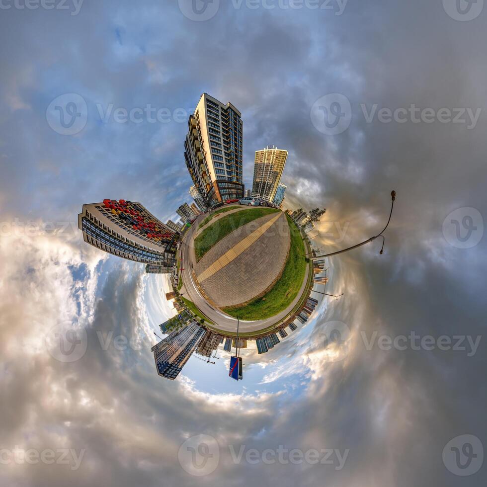 abstract swirling tiny planet spherical panorama of multi-storey buildings of skyscrapers of a residential complex in the form of a butterfly, bugs, crabs in blue sky photo