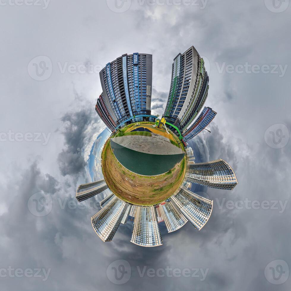 abstract swirling tiny planet spherical panorama of multi-storey buildings of skyscrapers of a residential complex in the form of a butterfly, bugs, crabs in blue sky photo