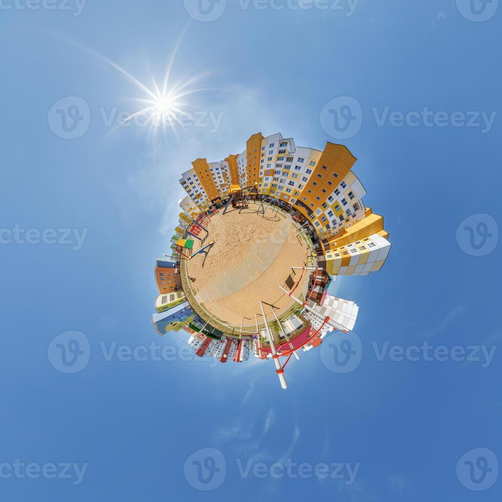 abstract swirling tiny planet spherical panorama of multi-storey buildings of skyscrapers of a residential complex in the form of a butterfly, bugs, crabs in blue sky photo
